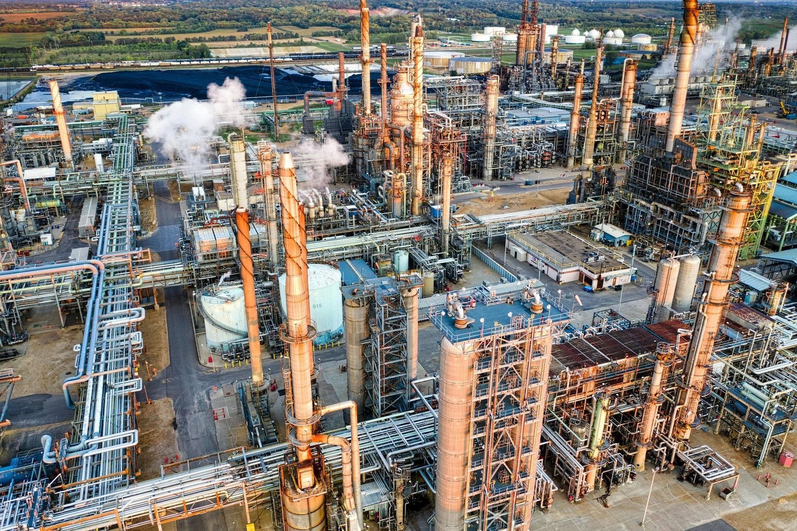 Vista aérea de refinaria com emissões de vapor